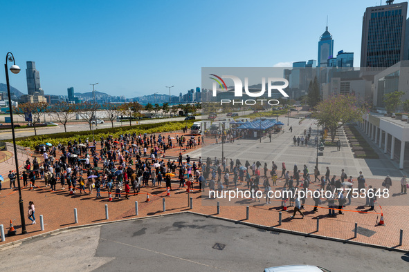 People queue up at an open air testing ground at Endinburgh Place in Central Hong Kong, China, on February 11, 2022.    