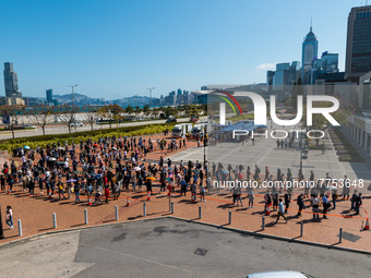 People queue up at an open air testing ground at Endinburgh Place in Central Hong Kong, China, on February 11, 2022.    (