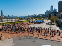 People queue up at an open air testing ground at Endinburgh Place in Central Hong Kong, China, on February 11, 2022.    (