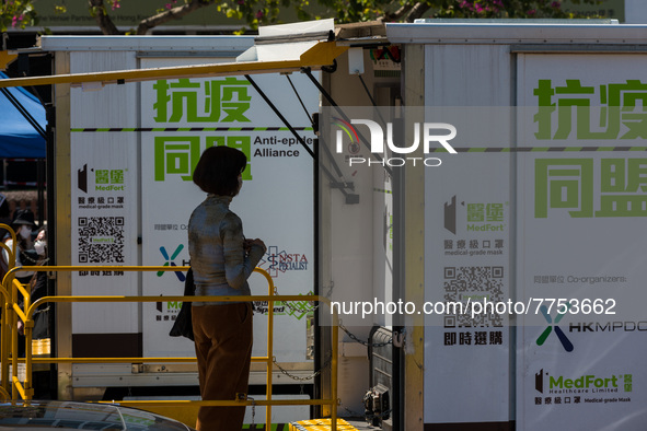 A woman expects her turn to be swabbed at a temporary test centre in Edinburgh Place in Central Hong Kong, China, on February 11, 2022.    