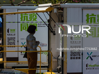 A woman expects her turn to be swabbed at a temporary test centre in Edinburgh Place in Central Hong Kong, China, on February 11, 2022.    (