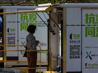 A woman expects her turn to be swabbed at a temporary test centre in Edinburgh Place in Central Hong Kong, China, on February 11, 2022.    (