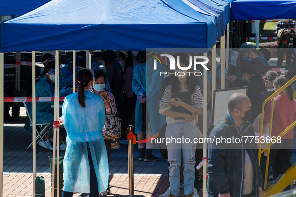 People queue as they wait to undergo a swab at a temporary COVID test centre in Edinburgh Place in Central Hong Kong, China, on February 11,...