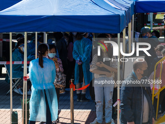 People queue as they wait to undergo a swab at a temporary COVID test centre in Edinburgh Place in Central Hong Kong, China, on February 11,...