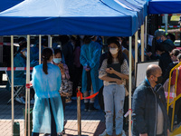 People queue as they wait to undergo a swab at a temporary COVID test centre in Edinburgh Place in Central Hong Kong, China, on February 11,...