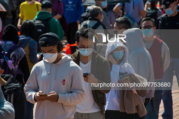 People queue at a temporary COVID test centre in Edinburgh Place in Central Hong Kong, China, on February 11, 2022.        