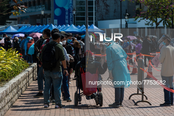 A man in wheelchair is assisted by staff  at a temporary COVID test centre in Edinburgh Place in Central Hong Kong, China, on February 11, 2...