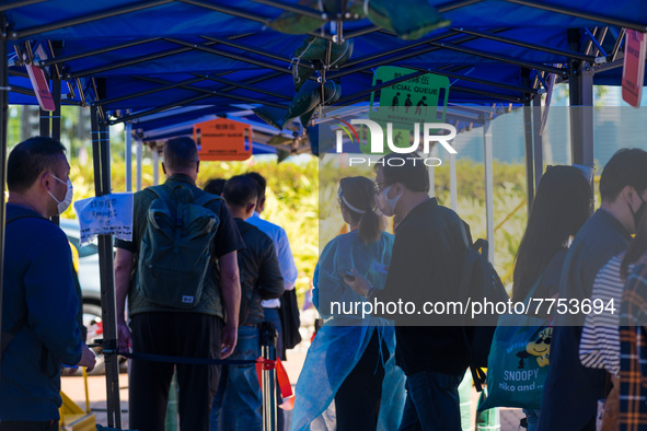 People queue up to get tested at a temporary COVID testing centre in Edinburgh Place, in Central Hong Kong, China, on February 11, 2022.    