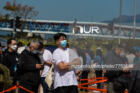 People queue up to get tested at a temporary COVID testing centre in Edinburgh Place, in Central Hong Kong, China, on February 11, 2022.    