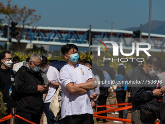 People queue up to get tested at a temporary COVID testing centre in Edinburgh Place, in Central Hong Kong, China, on February 11, 2022....