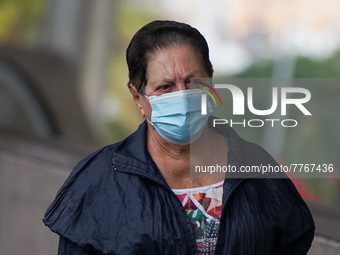 A woman wearing a face mask walks in Santa Cruz de Tenerife on 13 February 2022. (