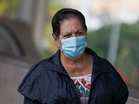 A woman wearing a face mask walks in Santa Cruz de Tenerife on 13 February 2022. (