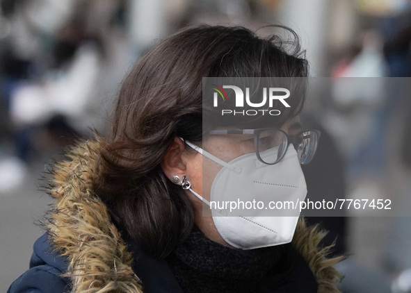 A woman wearing a face masks walks in Santa Cruz de Tenerife on 13 February 2022 