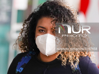 A woman wearing a face mask walks in Santa Cruz De tenerife on 13 February 2022. (