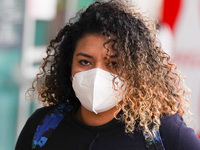 A woman wearing a face mask walks in Santa Cruz De tenerife on 13 February 2022. (