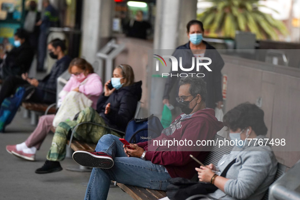 People wait at a bust stop in Santa Cruz de Tenerife on 13 February 2022. 