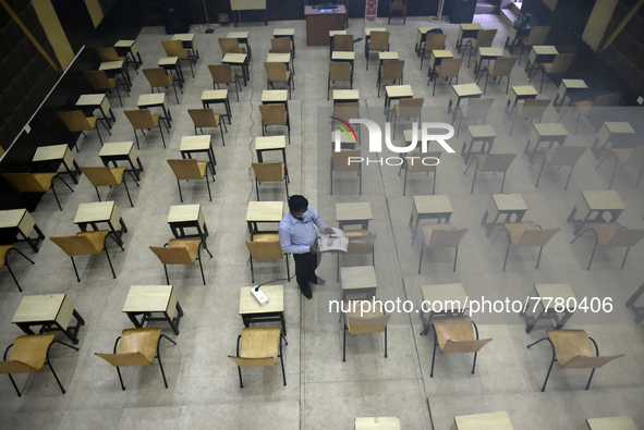 A man sanitises a primary school before it re-opens as the school close due to coronavirus surge in Kolkata, India, 15 February, 2022.  