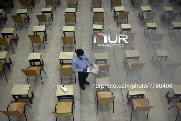 A man sanitises a primary school before it re-opens as the school close due to coronavirus surge in Kolkata, India, 15 February, 2022.  