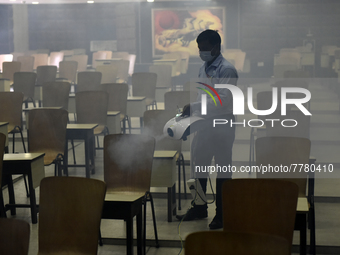 A man sanitises a primary school before it re-opens as the school close due to coronavirus surge in Kolkata, India, 15 February, 2022.  (