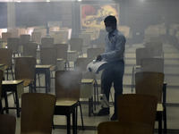 A man sanitises a primary school before it re-opens as the school close due to coronavirus surge in Kolkata, India, 15 February, 2022.  (