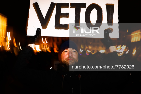 A man holds 'Veto' banner while demonstrating during 'Stop Lex Czarnek' protest at the Main Square in Krakow, Poland on February 15, 2022. S...