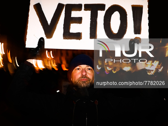 A man holds 'Veto' banner while demonstrating during 'Stop Lex Czarnek' protest at the Main Square in Krakow, Poland on February 15, 2022. S...