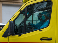 Ambulance staff in full PPE leave Queen Elisabeth hospital for another intervention, in Hong Kong, China, on February 17, 2022.  (