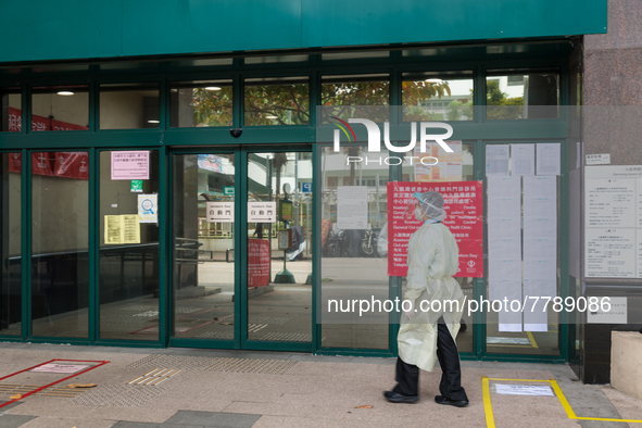 Healthcare staff in full PPE enters the Kowloon Bay Health Centre. This Centre was established as a one of the designated clinics for COVID...