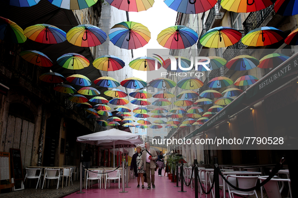 People walk on a street in Lisbon, Portugal, on February 18, 2022. Portuguese Government announced Thursday it is winding down its coronavir...