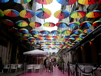 People walk on a street in Lisbon, Portugal, on February 18, 2022. Portuguese Government announced Thursday it is winding down its coronavir...