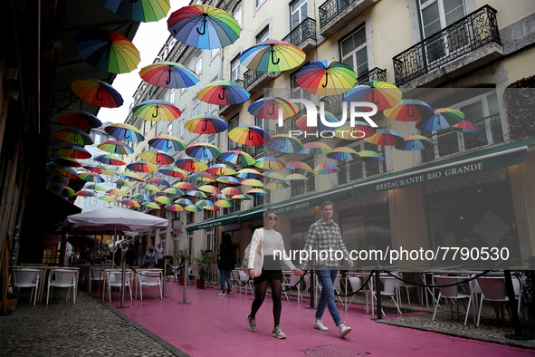 People walk on a street in Lisbon, Portugal, on February 18, 2022. Portuguese Government announced Thursday it is winding down its coronavir...