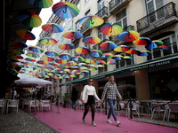 People walk on a street in Lisbon, Portugal, on February 18, 2022. Portuguese Government announced Thursday it is winding down its coronavir...