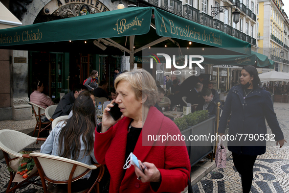 People walk by the A Brasileira cafe in the Chiado neighborhood in Lisbon, Portugal, on February 18, 2022. Portuguese Government announced T...