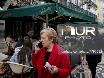 People walk by the A Brasileira cafe in the Chiado neighborhood in Lisbon, Portugal, on February 18, 2022. Portuguese Government announced T...