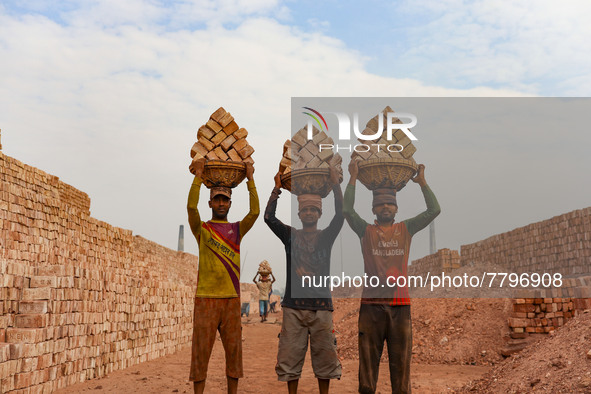 Workers poses for a photograph at a brickyard in Dhaka Bangladesh on February 20, 2022.