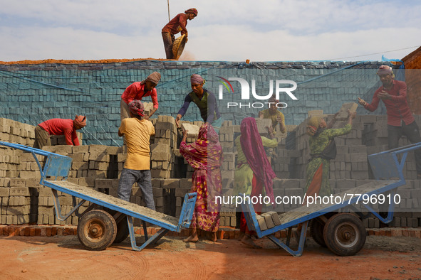 Workers are working at a brickyard in Dhaka Bangladesh on February 20, 2022.