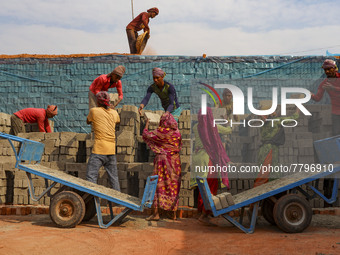 Workers are working at a brickyard in Dhaka Bangladesh on February 20, 2022.(