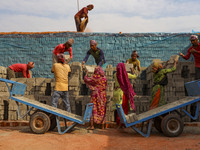 Workers are working at a brickyard in Dhaka Bangladesh on February 20, 2022.(