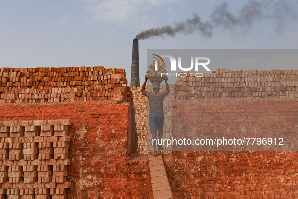 Workers are working at a brickyard in Dhaka Bangladesh on February 20, 2022.