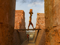 Workers are working at a brickyard in Dhaka Bangladesh on February 20, 2022.(