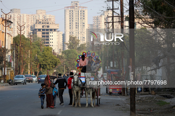 Men ride a horse cart used in wedding ceremonies to carry brides and grooms, at  a residential neighbourhood in Ghaziabad, on the outskirts...