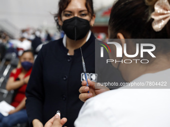 A nurse prepares a Sputnik-V dose booster  to supply it to a person inside Sport City facilities, during the mass vaccination campaign for c...