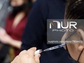 A nurse prepares a Sputnik-V dose booster  to supply it to a person inside Sport City facilities, during the mass vaccination campaign for c...