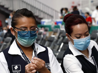 A nurse prepares a Sputnik-V dose booster  to supply it to a person inside Sport City facilities, during the mass vaccination campaign for c...