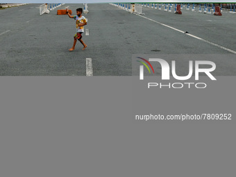 A child plays near an almost empty drive-thru vaccination site in Manila City, Philippines on February 23, 2022. Metro Manila mayors urged t...