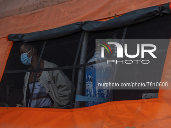 A patient looks out of the window of an emergency tent where the COVID-19 treatment was set up at Undata Hospital, Palu, Central Sulawesi Pr...