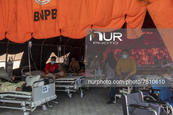 Patients sit in an emergency tent for COVID-19 treatment which was set up at Undata Hospital, Palu, Central Sulawesi Province, Indonesia on...