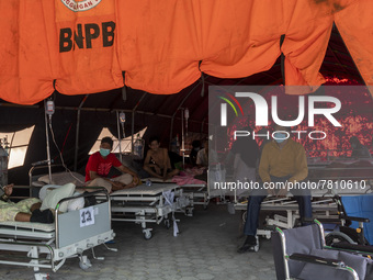 Patients sit in an emergency tent for COVID-19 treatment which was set up at Undata Hospital, Palu, Central Sulawesi Province, Indonesia on...