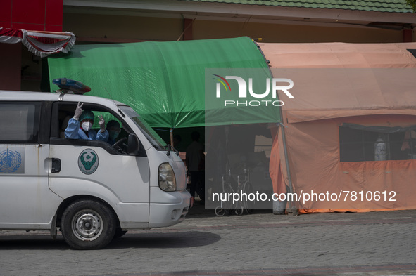 An ambulance driver raises his thumb after transporting patients to an emergency tent for COVID-19 treatment which was set up at Undata Hosp...