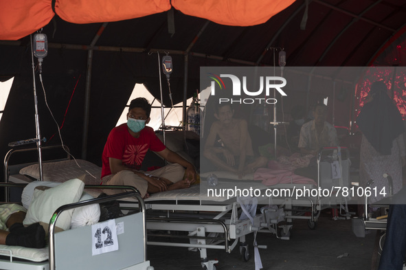 Patients sit in an emergency tent for COVID-19 treatment which was set up at Undata Hospital, Palu, Central Sulawesi Province, Indonesia on...